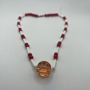 Red And White Beaded Necklace With An Amber Colored Glass Pendant